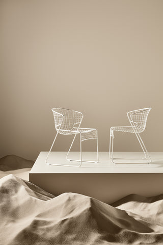 ND chairs on a platform with a beige background