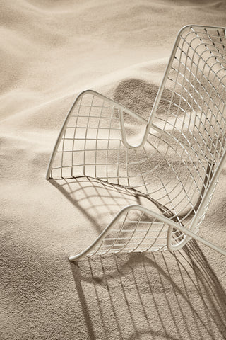 ND lounge chair on a sandy surface with a shadow