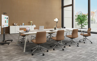 Modern office conference room with a large table and chairs, large windows, and a presentation board.