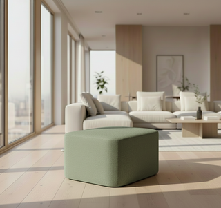 Modern living room with a green ottoman in the foreground