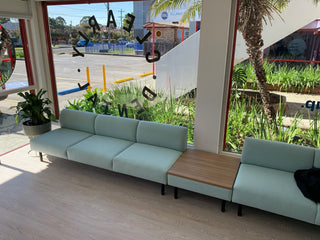 Light blue sofa with wooden table in a modern interior setting
