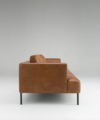Brown leather sofa on a gray background
