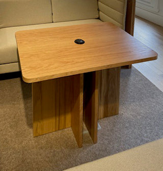 Wooden table with integrated power on a carpeted floor