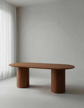 Wooden table with cylindrical legs in a minimalistic room.