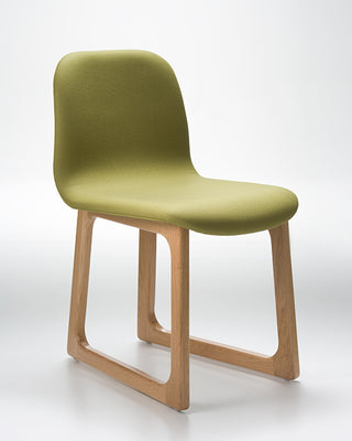 Green chair with wooden legs on a white background