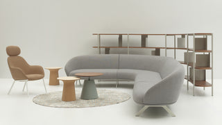 Modern living room with a gray sectional sofa, beige chair, and wooden tables on a white background.