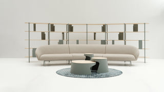 Modern beige sofa with two coffee tables in a minimalistic room