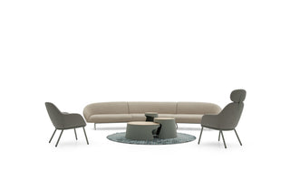 Modern outdoor furniture set with a sofa, two chairs, and a round table on a white background