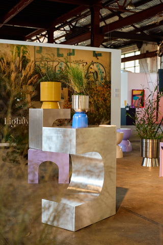 Blue/Nickel planter with decorative items in a stylish indoor setting