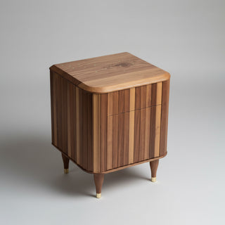 Wooden side table with fluting detail on a grey background