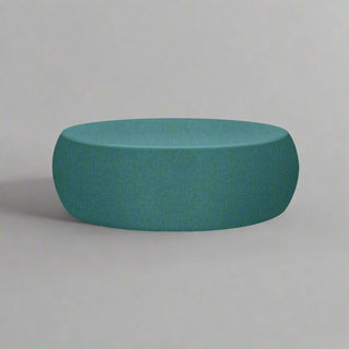 Teal ottoman on a grey background