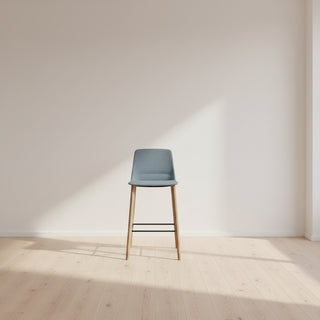 Bar stool with a gray cushioned seat and wooden legs on a white background