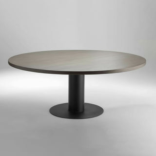 Round table with a dark wooden top and black base on a light gray background