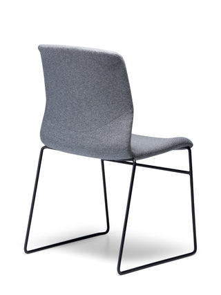 Odin Sled fabric back angle chair with black metal legs on a white background