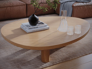 Oval wooden coffee table with decor