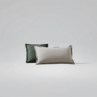 Two pillows, one green and one beige, on a light gray background