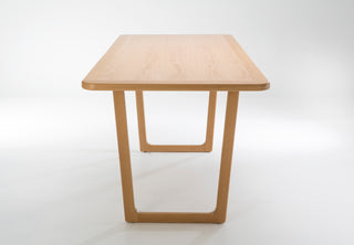 Wooden table with a minimalist design on a white background