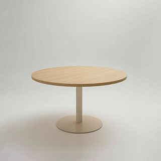 Round wooden top table on a grey background