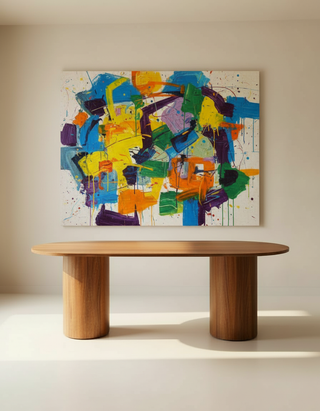 Wooden table in front of a colorful abstract painting on a beige wall