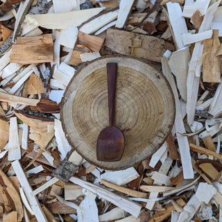 Small wooden serving spoon on wood slice