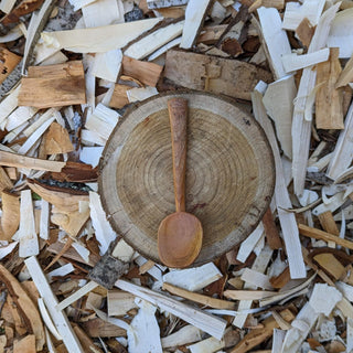 Wooden yogurt spoon on wood slice